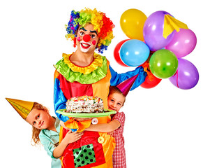 Clown keeps cake on birthday with two children. Isolated.
