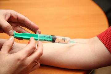 an injection syringe in hand