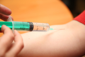 an injection syringe in hand