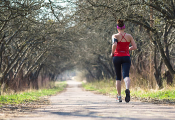 Sport woman jogging outside in morning
