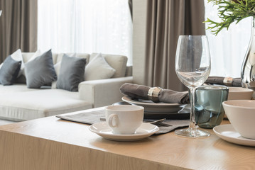 table set on wooden dinning room with cup of coffee