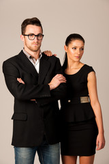 Confident business couple standing next to each other. Woman lea