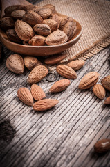 Closeup almond nuts wooden scoop