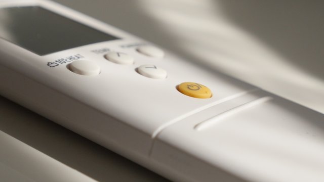 POWER button pressing on remote control for turning on AC device 4K 2160p 30fps UltraHD video - Air conditioner RC power button pressed with finger 4K 3840X2160 UHD footage 