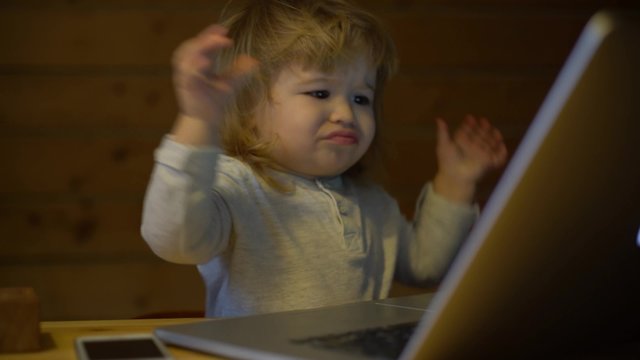 4K cute little boy with phone and computer angry with technology problems
