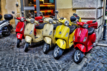 Fototapeta premium Scooters are parked on the city street in Rome, Italy