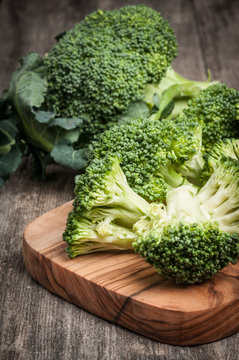 Fresh raw organic broccoli wooden background