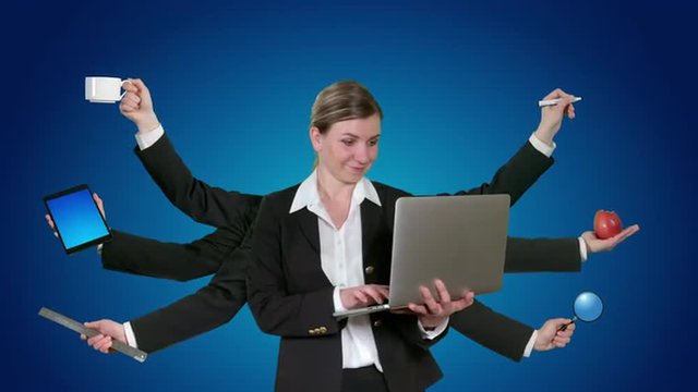 Young female holds a laptop and multi tasks on blue background