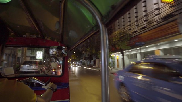 Tuktuk moving along a street in Bangkok, Thailand. Such motorbike taxis are called tuktuks in Thailand
