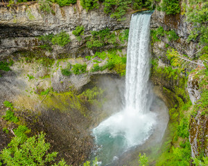 Fototapeta na wymiar Waterfall in deep forest of Rocky Mountains, Alberta, Canada.