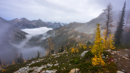 A small lake amidst the scenic autumn mountains shrouded in mist, HEATHER-MAPLE PASS LOOP TRAIL, Washington state