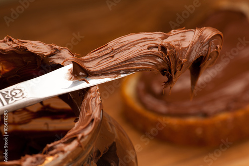Download "Knife full of sweet chocolate nougat spread on glass jar ... Yellowimages Mockups