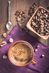 Coffee cup and beans above