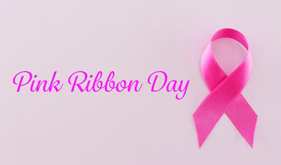 Satin ribbon sign on pink background