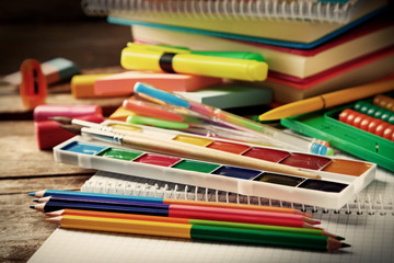 Bright school stationery on old wooden table