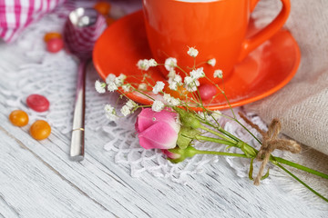 Cup of coffee and croissant with roses