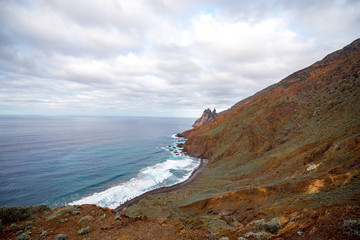 Rocky coastline with stone beach on the western part of La Gomera island near Arguamul village in Spain