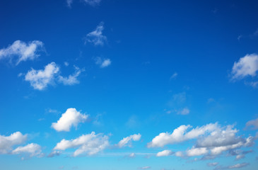 Blue sky background with tiny clouds