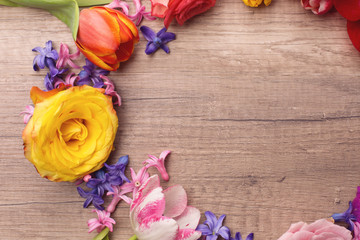 Beautiful multicolored flowers on wooden table