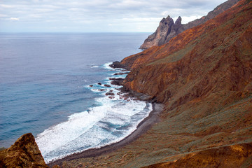 Rocky coastline with stone beach on the western part of La Gomera island near Arguamul village in Spain