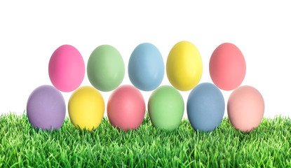 Easter eggs in green grass. Colorful holidays decoration