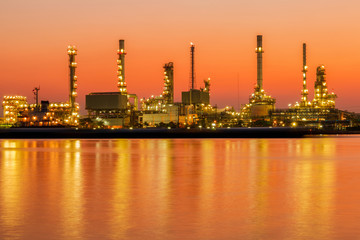 Obraz na płótnie Canvas Oil refinery factory in silhouette and sunrise sky