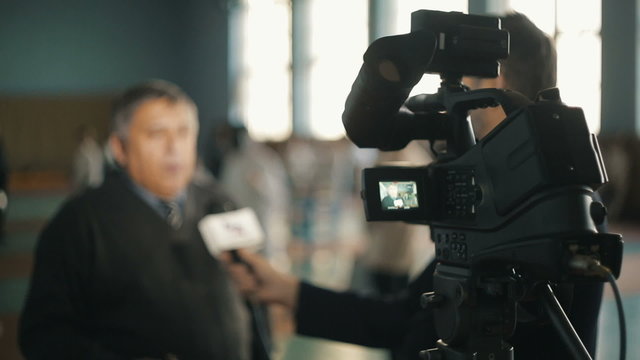 Journalists making interview with a man