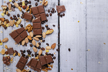 chocolate and various nuts on white vintage board