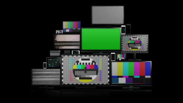 Many different types of screens. TVs, computer monitors, smartphones and tablets. They laid on each other in a pile isolated on a white background. They are all with no signal. With alpha and zoom in.