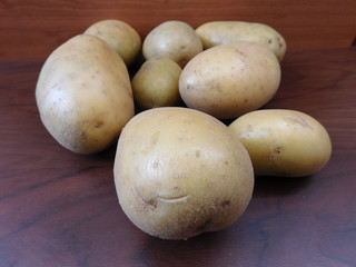 potatoes on wooden base