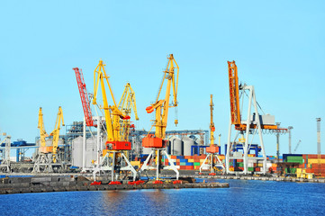 Port cargo crane and container over blue sky background