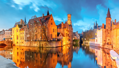 Scenic cityscape with a medieval fairytale town and tower Belfort from the quay Rosary, Rozenhoedkaai, at sunset in Bruges, Belgium