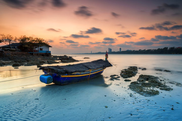 seascape, Fishing boats anchored along the beach at dusk.