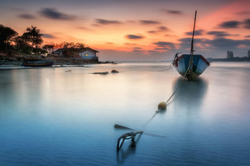 seascape, Fishing boats anchored along the beach at dusk.