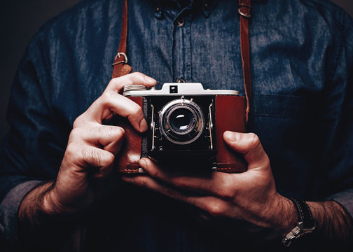 Retro camera in photographers hands