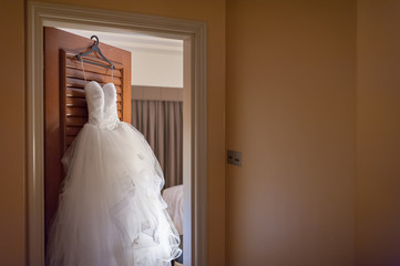 Wedding gown hanging on door