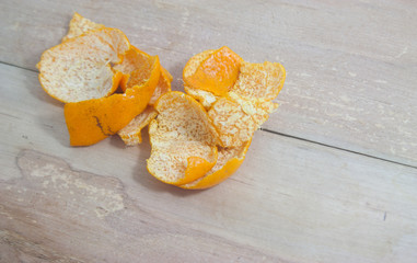 Tangerine peel on a wooden floor.