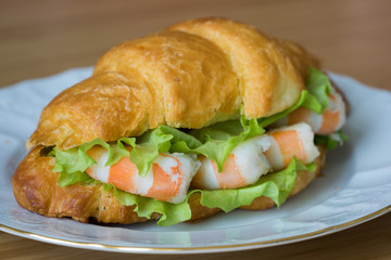 sandwich with srimps in croissant