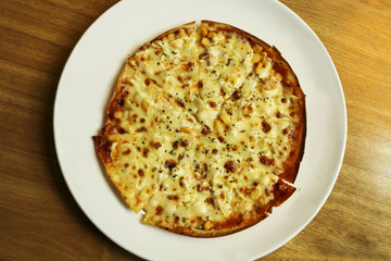 Italian pizza on white dish.