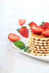 Waffles, mint and ripe strawberries.