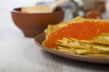 Pancakes with red caviar on a table