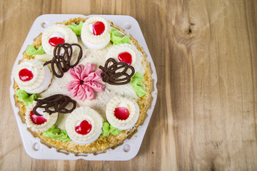 Cake with cream on a wooden table