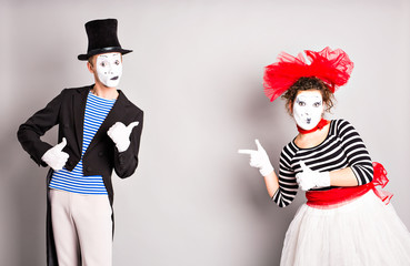 Your text here.  Colorful studio portrait of mimes with gray background. April fools day