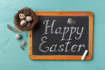 Phrase Happy Esther on chalkboard and nest with eggs