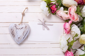 Flowers in pink colors with  decorative heart  and empty tag on