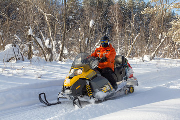 Athlete on a snowmobile.