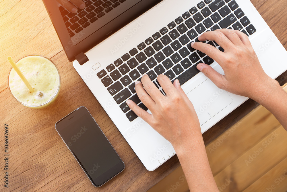 Poster hand using laptop computer on top angle view