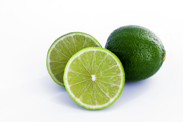 Limes with half isolated on white background