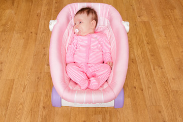 Baby girl newborn lying in the cradle 