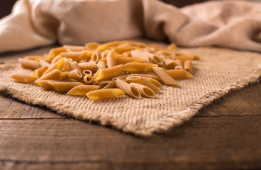Bowl of penne noodles in rustic style